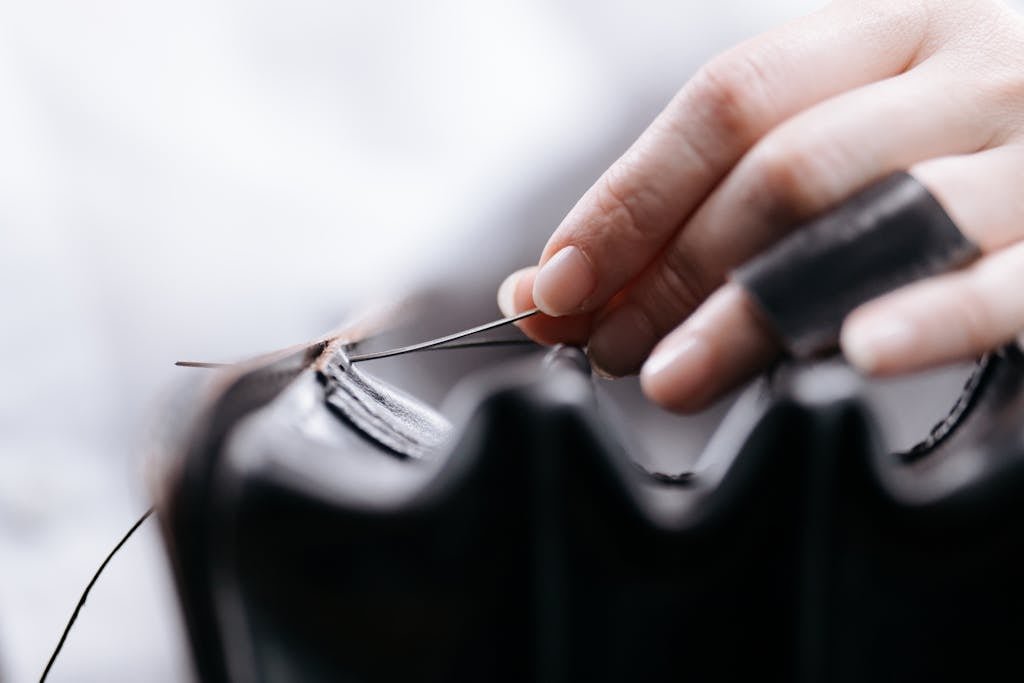 A Close-Up Shot of a Person Sewing