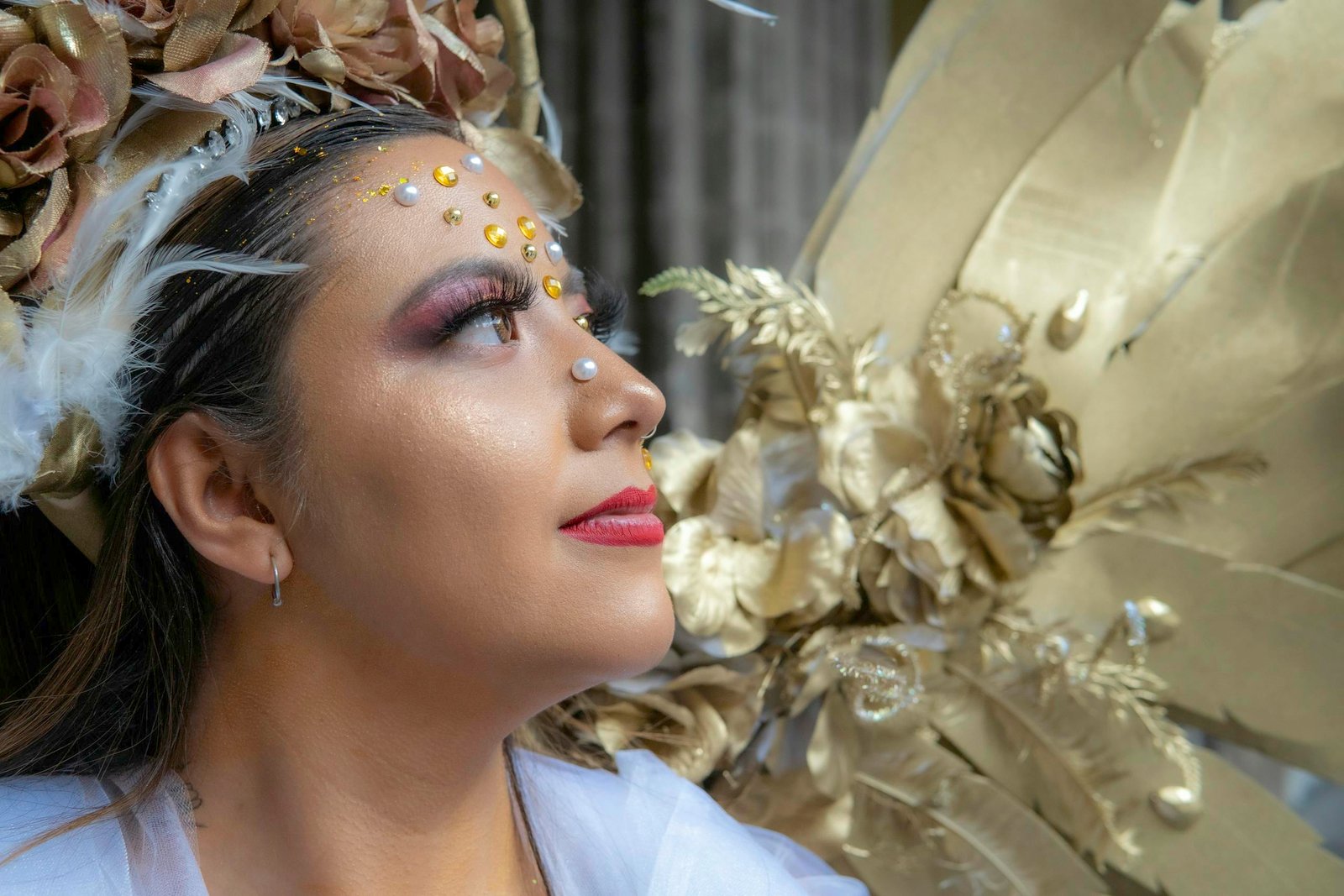 A woman with a gold headpiece and feathers