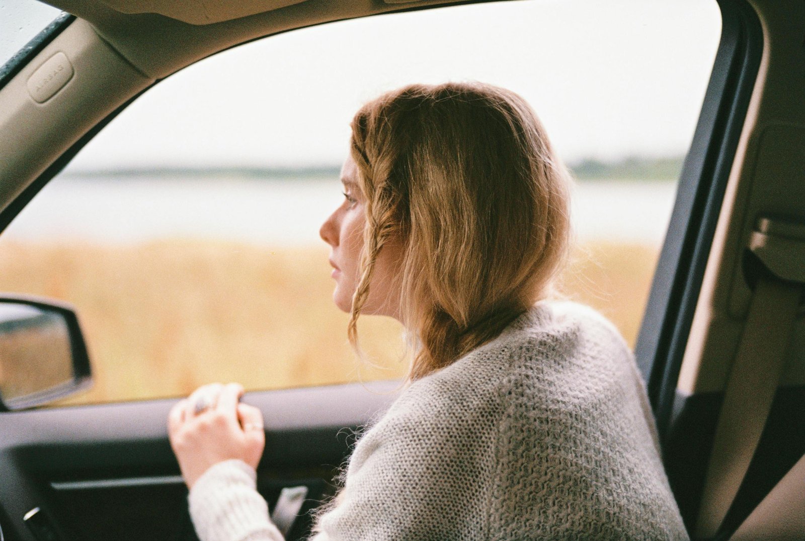 Woman in Sweater Inside a Car