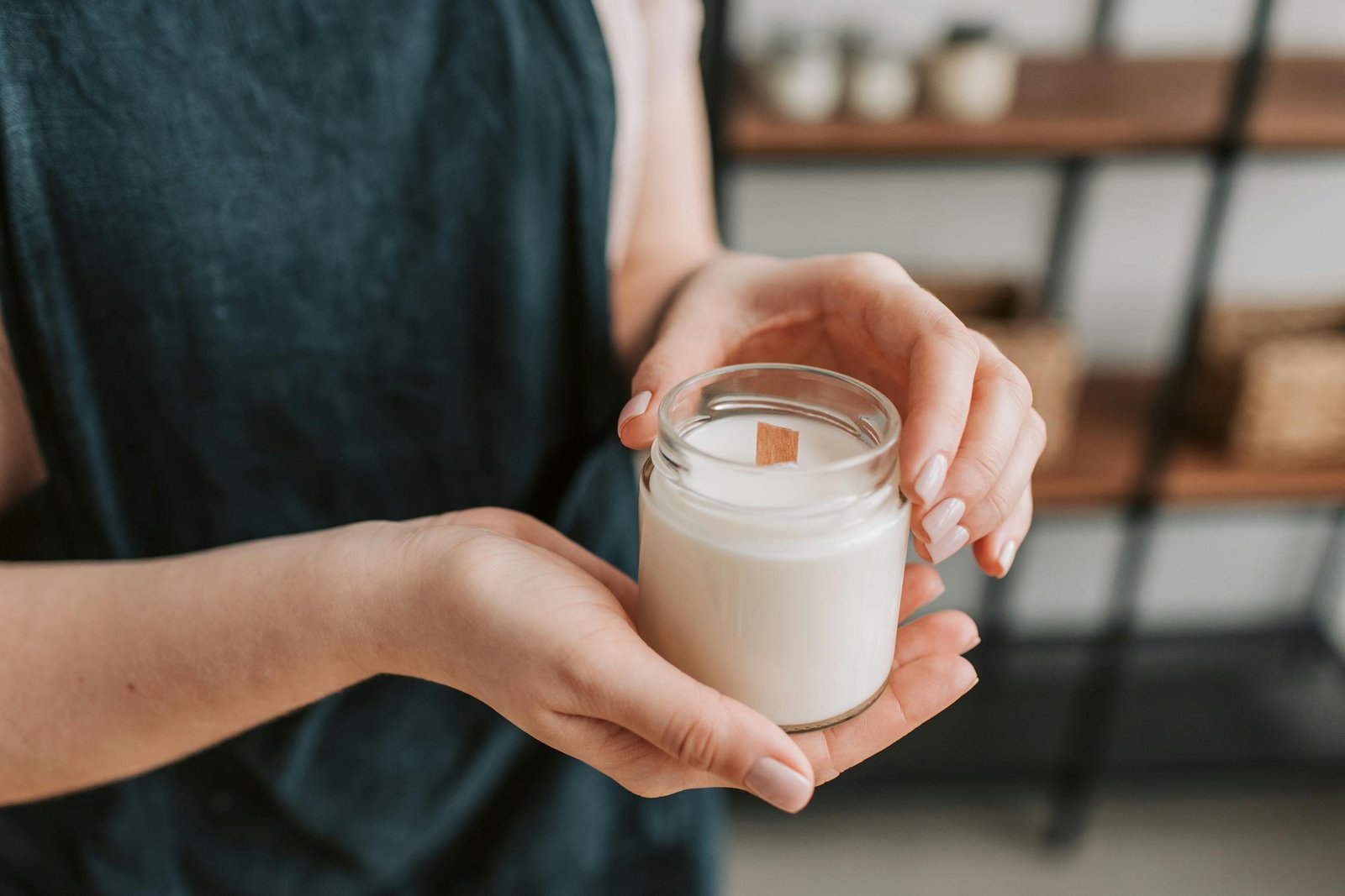 Person holding candle in a jar