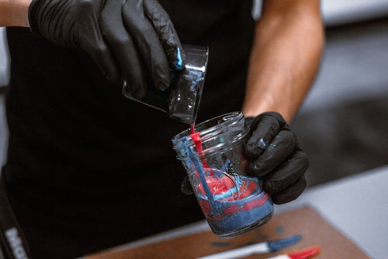 Photo of Person Combining Acrylic Paints in Mason Jar